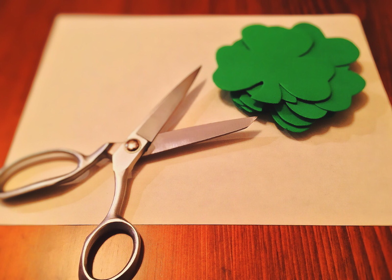near, two objects, irish, green color, indoors, high angle view, metal, scissors, 2K, eyeglasses, focus on foreground, shamrock, flowers, still life, wood - material