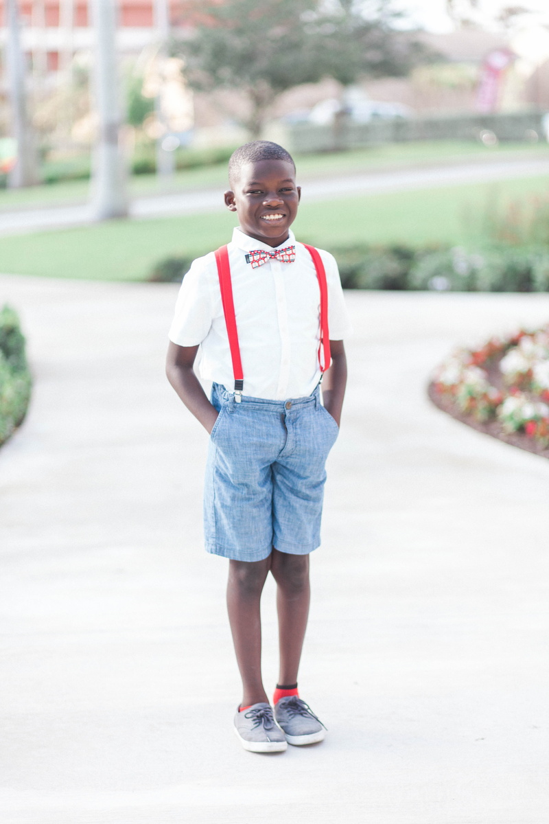 jean shorts, males, kid, street, facial expression, teenager, child, focus on foreground, blue, suspenders, wearing, shorts, young, blur, day, person, fun