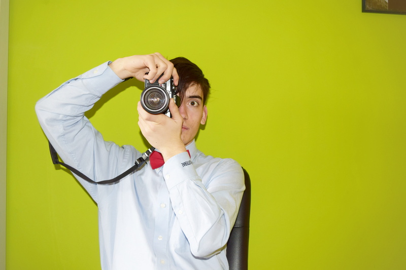young men, young adult, In the room, yellow, waist up, man, green background, photo, standing, capturing, real people, 5K, one Person, colored background