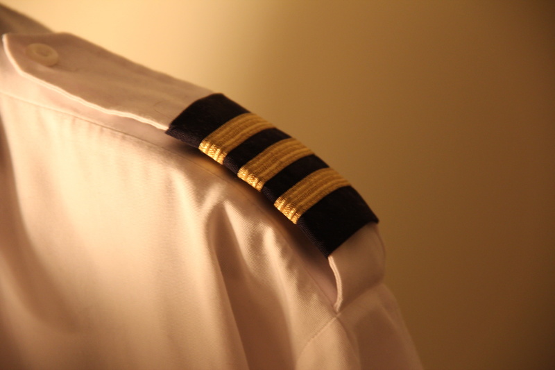 hand, human limb, close-up, indoors, limb, pilot, studio shot, button down shirt, business, aviation, colored background, people, luxury, adult, wealth