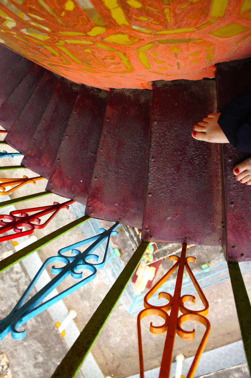 downstairs, multi colored, standing, low section, 4K, metal, railing, one person, human body part, human foot, architecture, real people, day, outdoors