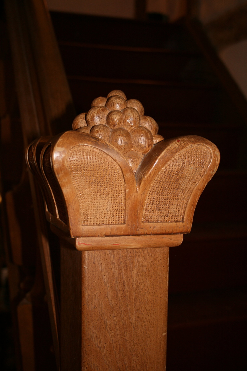 ornate, no people, craft, carved, art and craft, built structure, sculpture, artwork, religion, antique, indoors, stair doorknob, close-up, focus on foreground