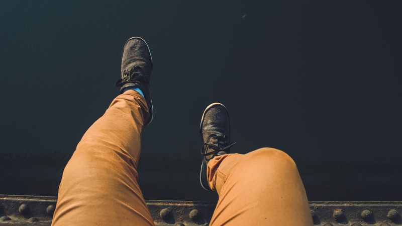 person, fashion, brown, adult, sneakers, metal, human limb, indoors, lying down, low section, footwear, steel, legs, human foot, wear, young adult, leisure activity