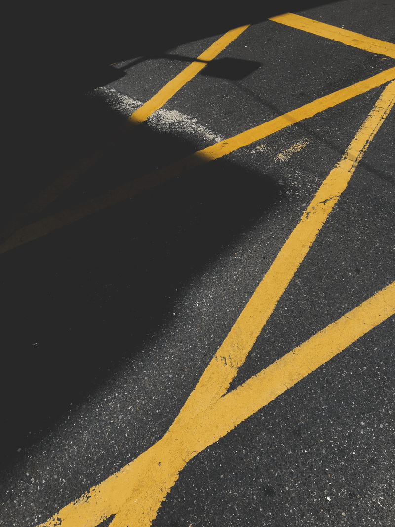 street photography, road, sign, shadow, day, pavement, safety, bitumen, guidance, marking, asphalt, transportation, dividing line, high angle view, no people