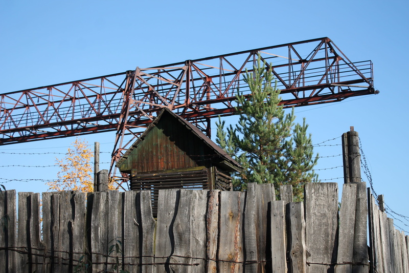 blue, industry, behind barbed wire, clear sky, area, boundary, metal, stairway to heaven, no people, nature, old, tree, secret object, low angle view, building exterior