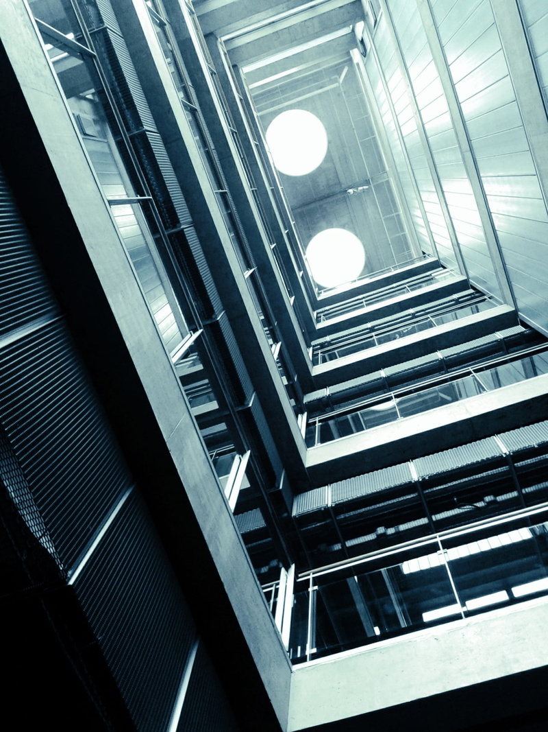 facade, low angle view, no People, repetition, skyscraper, city Life, illuminated, cascade, day, steps and staircases, architectural feature, reflection