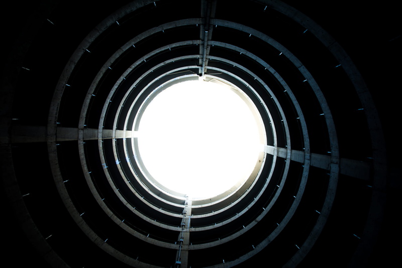 light at the end of the tunnel, architecture, balcony, geometric shape, directly below, built structure, pattern, tunnel, light, diminishing perspective