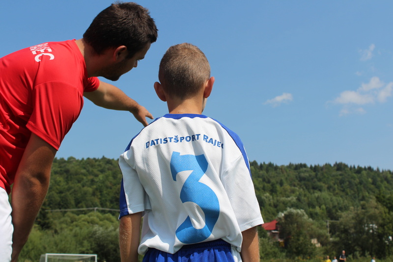standing, rear view, sky, childhood, sport, two people, football, boys, explain, males, council, child, coach, day, togetherness, competition, younger pupils