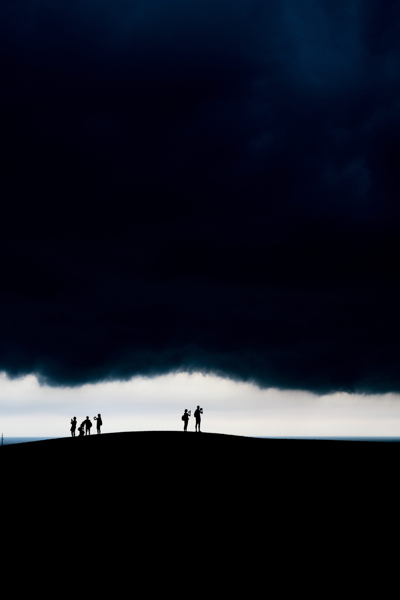 storm cloud, lifestyles, black, men, cloud - sky, hurricane, ride, dark, tranquil scene, sky, shadow, group of people, unrecognizable person, storm, horizon