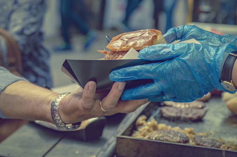 business finance and industry, hand, focus on foreground, selling, men, snack, street food, french food, giving, fast food, adult, consumerism, people
