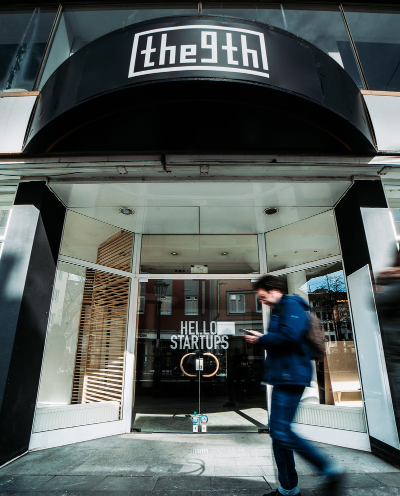 co-working, architecture, door, real people, bonn, jeans, full length, apparel, blurred motion, outdoors, hello startups, mode of transportation, transportation
