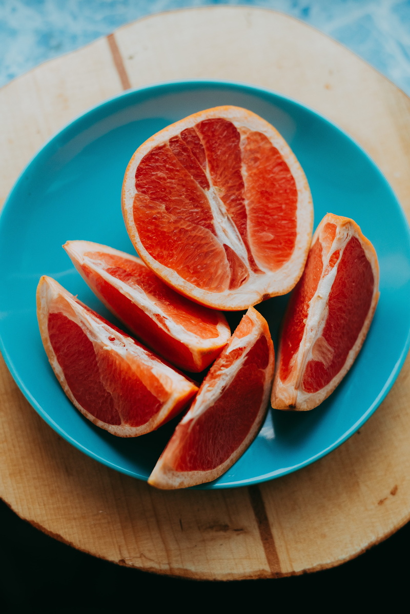 slice, orange color, blue, citrus fruit, no people, ripe, blood orange, table, orange, cross section, fruits, fruit, 5K, wellbeing, food and drink, orange - fruit