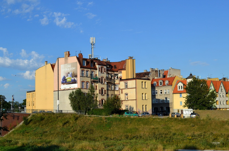 cloud - sky, sunlight, land, plant, monument, house, building, built structure, city, residential district, outdoors, old buildings, grass, sky, tree, poznan