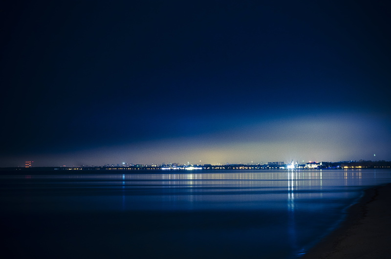 sky, scenics - nature, night, reflection, blue, royalty  images, illuminated, city, lights, beach, outdoors, sea, light, nature, 4K, water, land, copy space