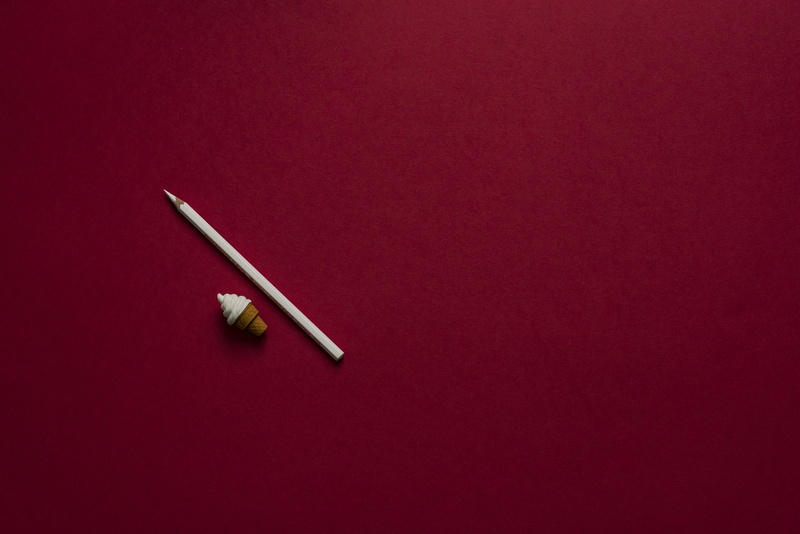 red background, chopsticks, two objects, no people, toy, high angle view, art, simplicity, color, background, white, red, cone, 5K, texture, icecream cone