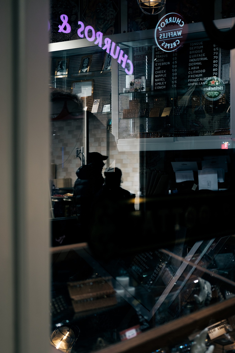 meal, retail, metropolis, sign, communication, night, display, glass - material, people, food and drink, town, electronics, store, text, lighting, indoors