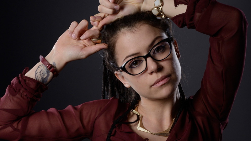 women, holding, portrait, studio shot, Orphan Black, human arm, young adult, one person, indoors, eyeglasses, hair, looking at camera, jewelry, glasses