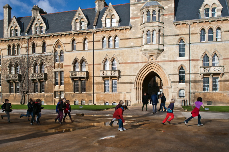 the past, place of worship, day, lifestyles, children, history, women, outdoors, running, near, large group of people, jumping puddles, men, oxford, group of people