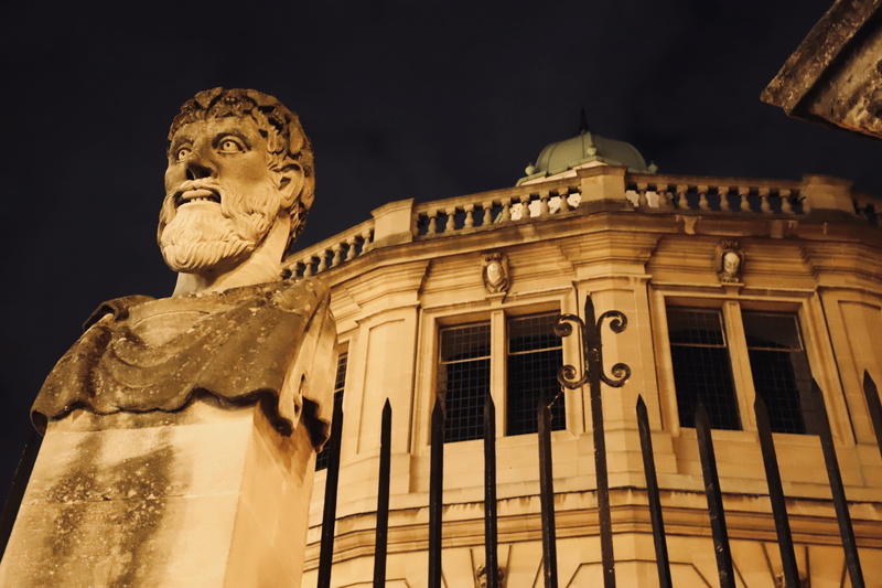 sky, the sheldonian theatre, god, architecture, 5K, male likeness, low angle view, craft, statue, tourism, sculpture, beardy man, head, night, united kingdom