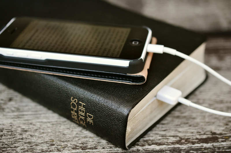 two objects, download, internet, high angle view, bible, focus on foreground, black color, ipod, digital, indoors, read online, mobile phone, no people