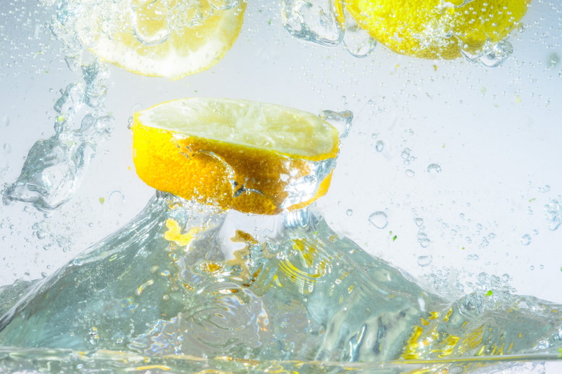 splashing, studio shot, movement, immersion, water splashes, lemon soda, spray, 2K, motion, inject, glass, drink, lemon, bubble, no people, indoors, food and drink