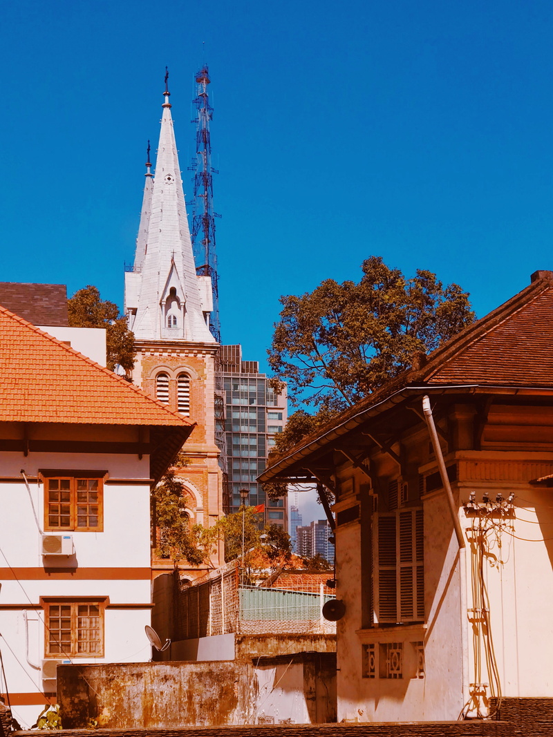 outdoors, architecture, brown, belief, spire, urban, blue, housing, vietnam, countryside, sky, building, spirituality, concrete, rural, building exterior