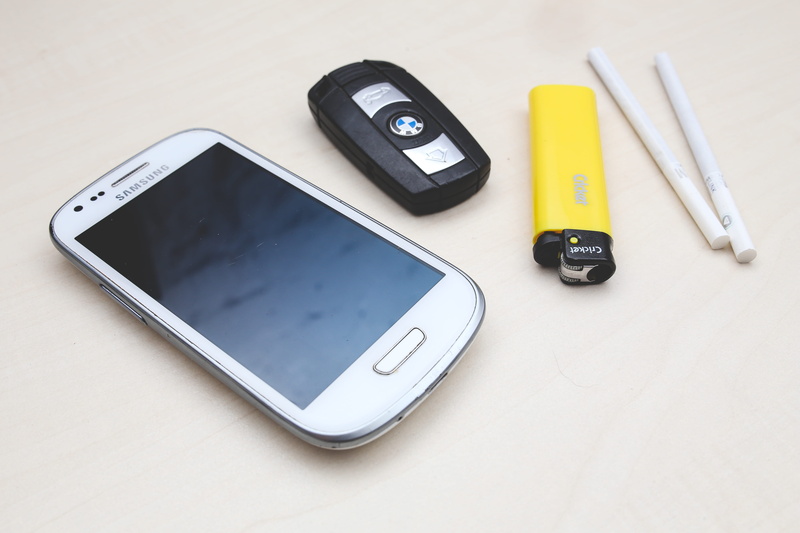 studio shot, car, small group of objects, smart phone, lighter, cigarettes, connection, high angle view, still life, smartphone, portability, white background