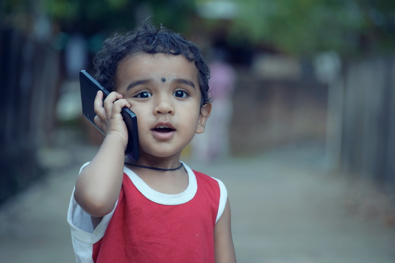children only, child, mouth open, mobile, toddler, leisure activity, cellphone, lifestyles, day, photography, red, kid, cute, front view, fun, boys, casual clothing