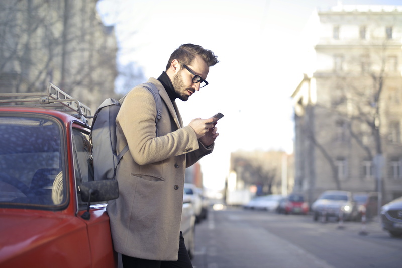 standing, telephone, modern, leaning, road, beard, transportation, young men, backpack, wireless technology, red, communication, coat, daytime, connection