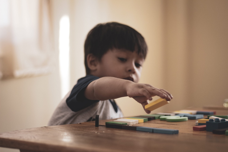 childhood, cute, child, holding, kid, concentration, block, males, casual clothing, portrait, one person, toy, learning, playing, brown hair, looking down