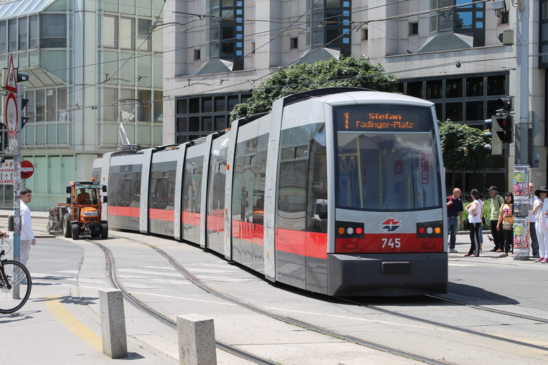 built structure, tram, outdoors, city, real people, transportation, vehicle, wiener lines, incidental people, transport system, bim, train - vehicle, train