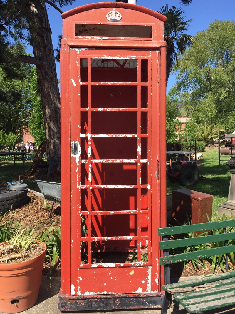 phone box, blue sky, red, sunlight, call, day, built structure, telephone booth, connection, telephone, mode of transportation, no people, phone, old, broken