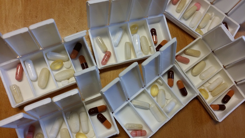 large group of objects, in a row, food and drink, variation, high angle view, still life, choice, table, doctor, tablets, box - container, capsule, health check