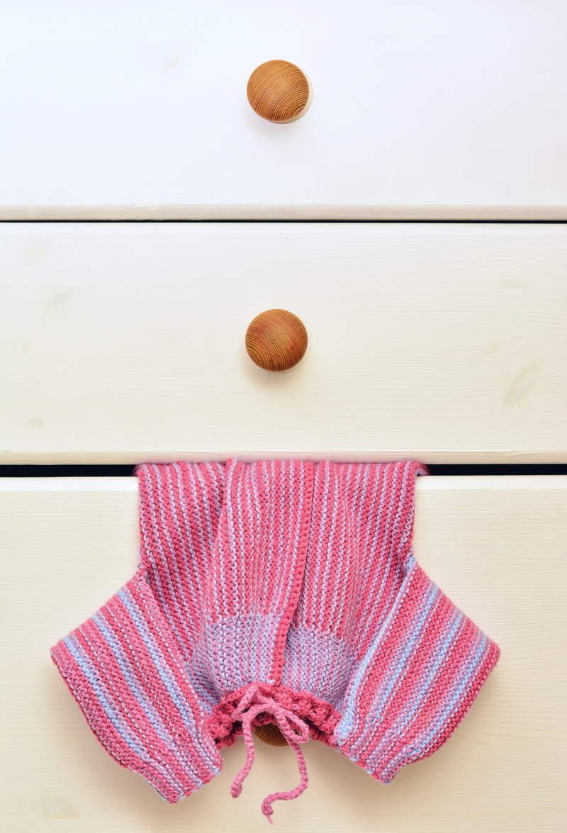 food and drink, cute, knit, chest of drawers, new born, toy, textile, wool, 5K, focus on foreground, high angle view, infant, clean, jacket, girl, knitted