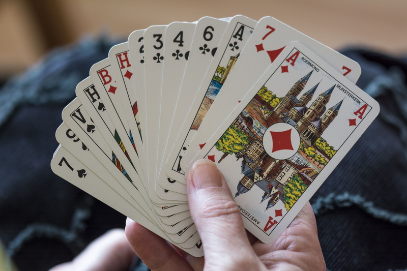 one person, number, hand, leisure activity, game, arts culture and entertainment, bridge, recreational pursuit, leisure games, adult, relaxation, opportunity