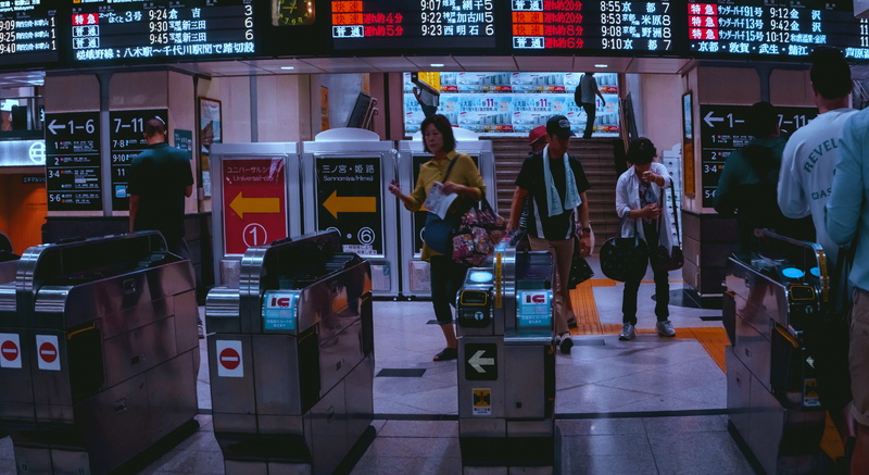 standing, leisure activity, machine, rear view, people, night, lcd screen, person, lighting, display, group of people, lifestyles, town, city, group, airport