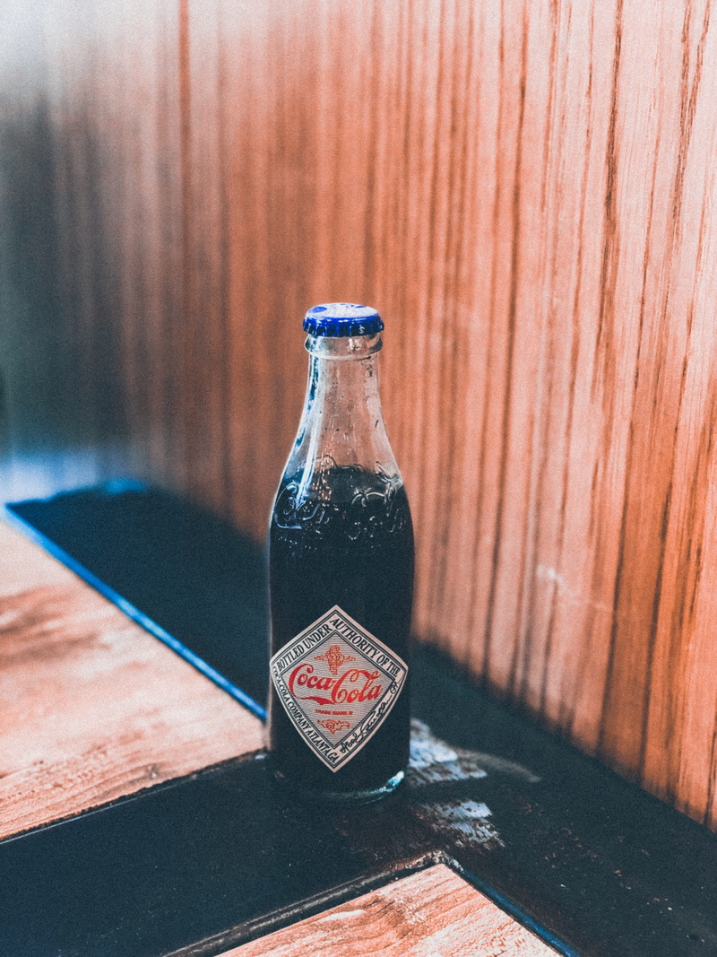 beer, black, close-up, trademark, nature, table, 4K, brown, wood, alcohol, liquor, coke, cola, still life, bottle, plywood, glass, transparent, indoors