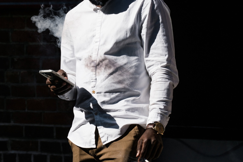 casual clothing, lifestyles, midsection, leisure activity, clothing, Smoke, Watch, young adult, indoors, man, smooking, Men, black background, front view