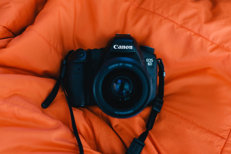 person, human body part, 5K, technology, indoors, orange color, modern, camera lens, camera, strap, harness, digital camera, electronics, black, lens - eye
