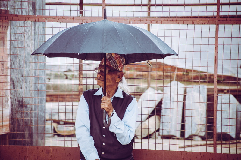 safety, wet, holding, daylight, rain, human, building exterior, adult, male, weather, mature adult, black, real people, umbrella, protection, sunshade