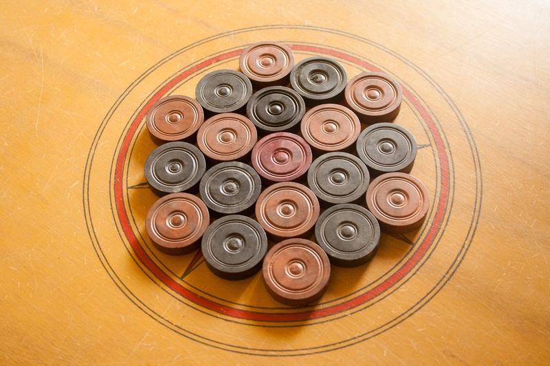 food and drink, shape, carrom, pattern, black color, pieces, indoors, design, no people, choice, coins, flooring, game, karrom, large group of objects