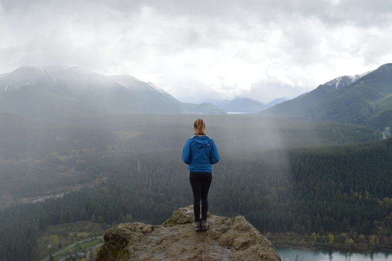 non-urban scene, hoodie, peak, leisure activity, outdoors, person, one person, blue, valley, nature, environment, casual clothing, clouds, vacations, 5K