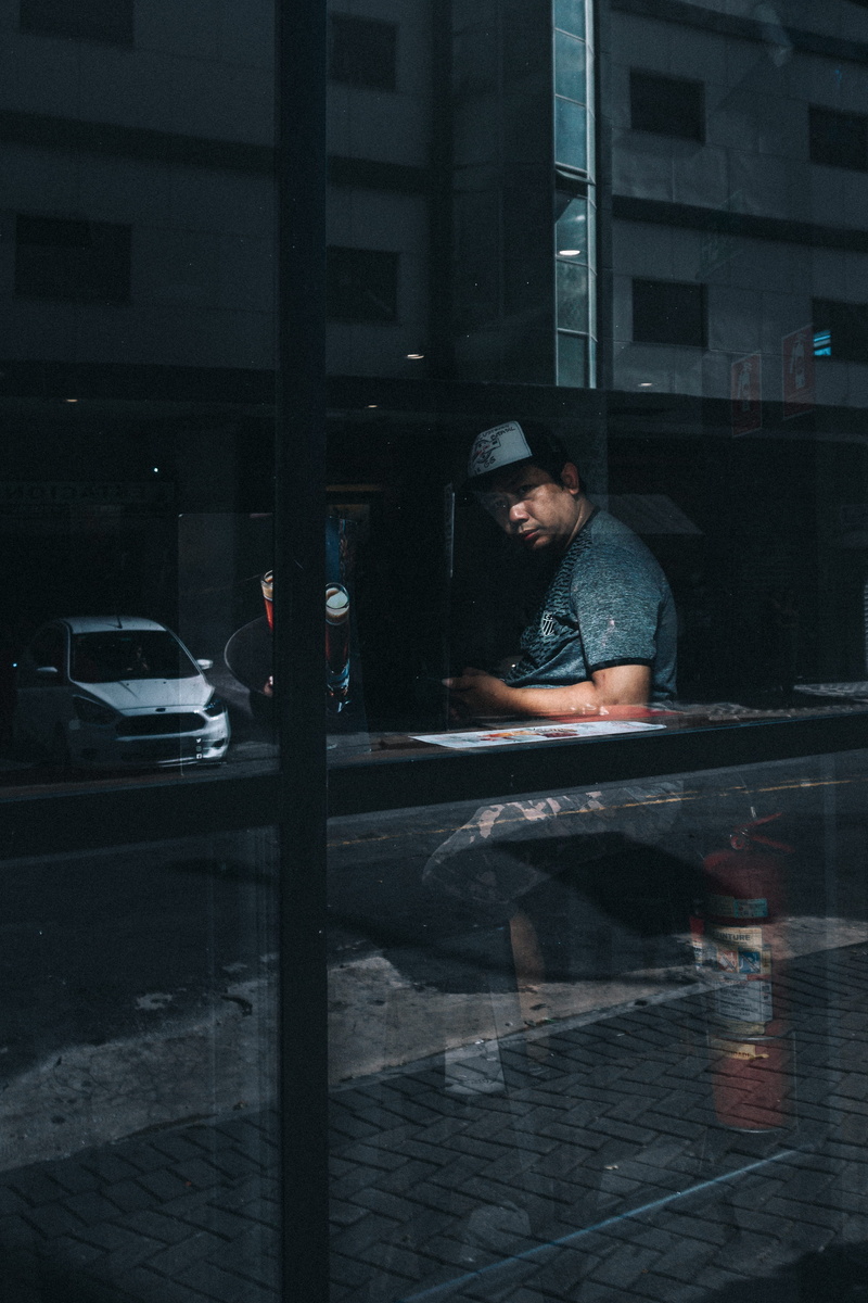 cap, fashionable, urban photography, person, transportation system, model, adult, urban, outfit, road, land vehicle, motor vehicle, sitting, night, man