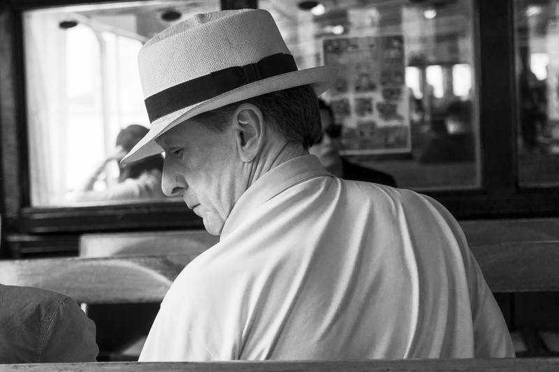 restaurant, wear, gentleman, hat, black and white, headshot, man, side view, indoors, mid adult, window, men, 2K, males, focus on foreground, photo, portrait