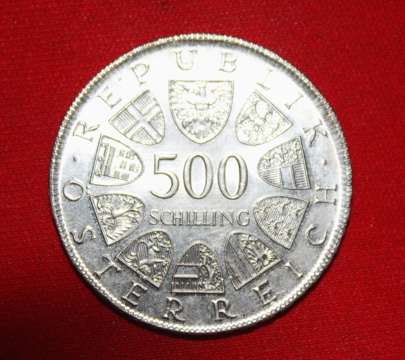 single object, currency, metal, red background, schilling, shape, coin, business, number, silver colored, circle, dollar sign, wealth, text, studio shot