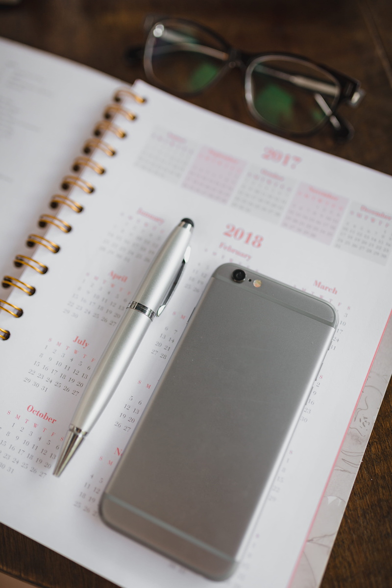 personal accessory, education, diary, portable information device, note pad, eyeglasses, no people, indoors, mobile phone, technology, publication, paper