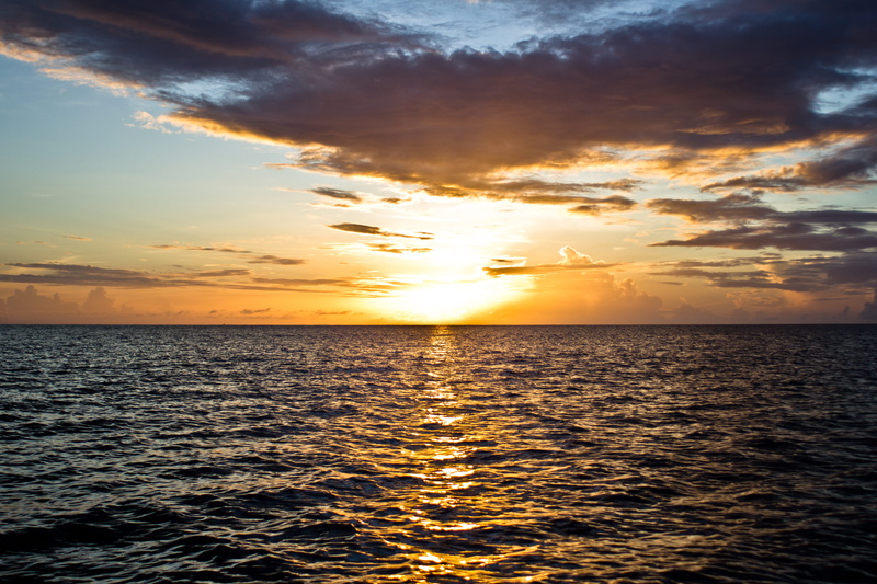 sunset, reflection, orange color, beauty in nature, sea, outdoors, nature, caribbean, ocean, tranquil scene, waterfront, saint vincent and the grenadines