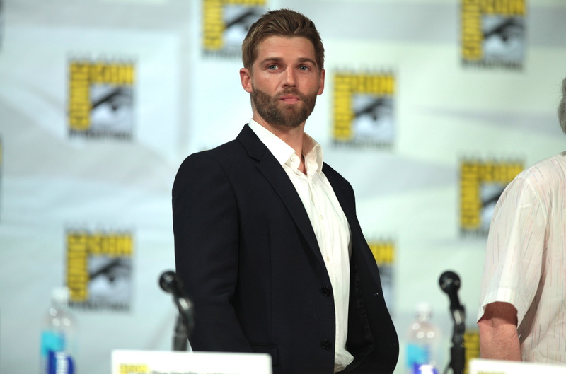 business person, young adult, focus on foreground, one person, well-dressed, standing, portrait, businessman, adult, young men, men, looking at camera