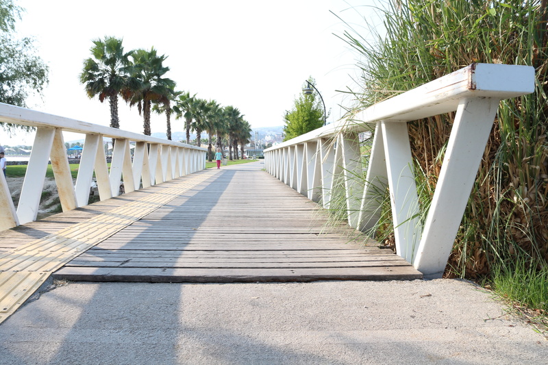 architecture, direction, sidewalk, shadow, no people, outdoors, summer, road, the way forward, wood - material, sunlight, sky, connection, diminishing perspective