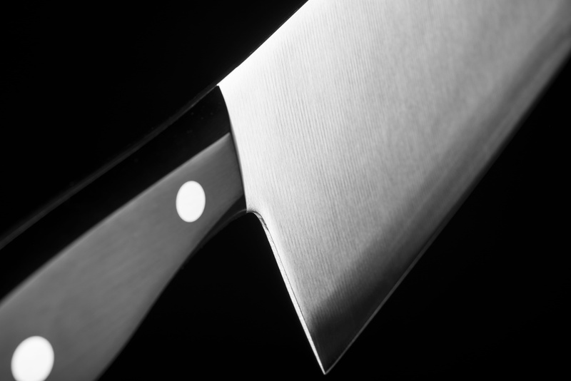 selective focus, human leg, handle, human limb, close-up, one person, gray, human hand, skin, cleaver, limb, grayscale, indoors, focus on foreground, 5K